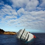 The Costa Concordia cruise ship which ran aground off the west coast of Italy at Giglio island lies on its side, half-submerged and threatening to slide into deeper waters